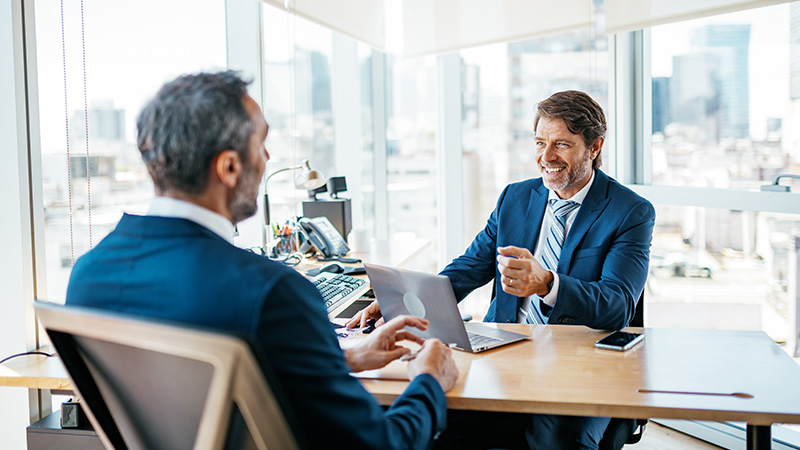 two business professionals talking in office