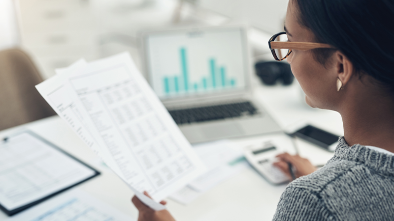 Closeup shot of an unrecognisable businesswoman calculating finances in an office
