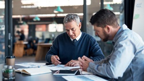 two men looking at finances