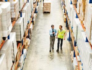 Two small business employees looking at warehouse inventory for their small business